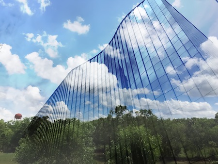 EPD: Achieving Green Goals With HSS 1 Sustainability - blue skies with green trees by a building